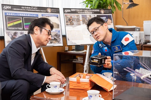 金井宇宙飛行士からタンパク質実験の説明を受ける松山大臣